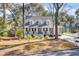 Charming home featuring a cozy front porch, symmetrical design, and mature trees in a desirable neighborhood at 1048 Wharf Indigo Pl, Mount Pleasant, SC 29464