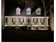 Charming home with a cozy front porch, complete with rocking chairs, and lovely landscaping at 1048 Wharf Indigo Pl, Mount Pleasant, SC 29464