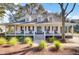 Inviting front porch with classic rocking chairs and a charming entrance, perfect for relaxing outdoors at 1048 Wharf Indigo Pl, Mount Pleasant, SC 29464