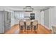 Bright kitchen features white cabinets, stainless appliances, large island with seating, and wood floors at 1048 Wharf Indigo Pl, Mount Pleasant, SC 29464