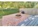Brick patio with a built-in fire pit, wooden deck and privacy fence at 1048 Wharf Indigo Pl, Mount Pleasant, SC 29464