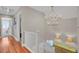 Bright stairway features wood flooring and a decorative gold chandelier at 1048 Wharf Indigo Pl, Mount Pleasant, SC 29464