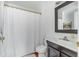 Traditional-style bathroom features a shower with a curtain, toilet, and vanity with gray cabinets at 107 Bogard St, Charleston, SC 29403