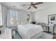 This light-filled bedroom has a bed facing windows and desk for work or study at 107 Bogard St, Charleston, SC 29403