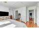 Bright bedroom with hardwood floors and white walls and trim with an open doorway to another room at 107 Bogard St, Charleston, SC 29403