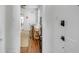 Bright dining area with hardwood floors, a jute rug, and white dining chairs at 107 Bogard St, Charleston, SC 29403