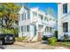 Two-story home with a large front porch and stairs leading up to the entrance at 107 Bogard St, Charleston, SC 29403