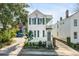 Inviting two-story home with a cozy second-story porch and gated driveway at 107 Bogard St, Charleston, SC 29403