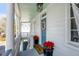 Welcoming porch featuring elegant columns, a wreath, and potted poinsettias at 107 Bogard St, Charleston, SC 29403
