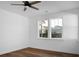 Minimalist bedroom with wood floors, white walls, and a ceiling fan at 1137 Moss Grove Dr Dr, Moncks Corner, SC 29461