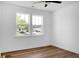 Bright bedroom featuring hardwood floors, white walls, large windows and ceiling fan at 1137 Moss Grove Dr Dr, Moncks Corner, SC 29461