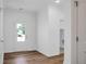 Inviting foyer featuring hardwood floors, a front door with glass panels, and modern trim details at 1137 Moss Grove Dr Dr, Moncks Corner, SC 29461