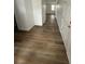 Long hallway featuring wood-look flooring, white trim, and multiple access doors at 1137 Moss Grove Dr Dr, Moncks Corner, SC 29461