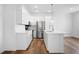 Well-lit kitchen with white cabinets, stainless steel appliances, and a center island with sink at 1137 Moss Grove Dr Dr, Moncks Corner, SC 29461