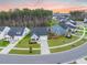 Aerial view of a light blue home with manicured lawns, surrounded by trees and neighboring houses at 114 Belfort Pl, Summerville, SC 29486