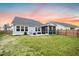 Backyard with a covered patio, barbecue grill, privacy fence, and a view of a neighboring light-blue home at 114 Belfort Pl, Summerville, SC 29486
