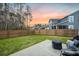 Backyard with lush green grass, a concrete patio with seating, and a privacy fence in the background at 114 Belfort Pl, Summerville, SC 29486