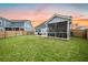 Grassy backyard with a fenced perimeter and a screened-in porch attached to the light blue home at 114 Belfort Pl, Summerville, SC 29486