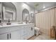 Modern bathroom with double sinks, framed mirrors, and a shower with a striped curtain at 114 Belfort Pl, Summerville, SC 29486