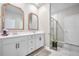Modern bathroom featuring double sinks, white cabinetry, framed mirrors, and a glass-enclosed shower at 114 Belfort Pl, Summerville, SC 29486