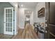 Bright and airy foyer with wood floors, glass paneled door, and decorative accents at 114 Belfort Pl, Summerville, SC 29486
