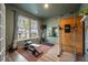 A well-lit home gym with exercise equipment, sauna, weights, and view of the neighborhood at 114 Belfort Pl, Summerville, SC 29486