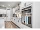 Contemporary kitchen with stainless steel double ovens, stylish white cabinets, and subway tile backsplash at 114 Belfort Pl, Summerville, SC 29486