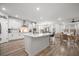 Spacious white kitchen with a large center island, stainless steel appliances, and ample counter space at 114 Belfort Pl, Summerville, SC 29486