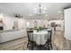 Open-concept living room and dining area with hardwood floors and a large window at 114 Belfort Pl, Summerville, SC 29486