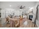 Open-concept living room with fireplace, fan, hardwood floors, and stylish decor at 114 Belfort Pl, Summerville, SC 29486