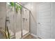 A modern shower with glass doors, tiled walls, rainfall shower head, and plants at 114 Belfort Pl, Summerville, SC 29486