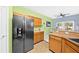 A modern kitchen features a large stainless steel refrigerator and ample wood cabinet storage at 1227 Cosmos Rd, Summerville, SC 29483