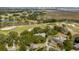 Aerial view of a home near marshlands, a golf course and the Ravenel Bridge with lush tree coverage at 1429 Burningtree Rd, Charleston, SC 29412