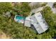 Aerial view of a home with a private pool and lush greenery providing a serene and secluded atmosphere at 1429 Burningtree Rd, Charleston, SC 29412