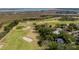 Aerial view of a residential area near a golf course, with lush green fairways and natural marshlands nearby at 1429 Burningtree Rd, Charleston, SC 29412