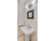 Bathroom pedestal sink with chrome fixtures and a mosaic mirror above at 1429 Burningtree Rd, Charleston, SC 29412