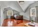 Cozy bedroom features a vaulted ceiling, natural light, and gleaming wood floors at 1429 Burningtree Rd, Charleston, SC 29412
