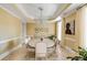 Formal dining room with chandelier, neutral tones, and view to the garden at 1429 Burningtree Rd, Charleston, SC 29412