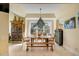 Dining room with a large window, dining table with seating for six, and custom storage cabinets at 1429 Burningtree Rd, Charleston, SC 29412