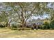Expansive two-story home exterior with lush landscaping, brick foundation, and outdoor patio at 1429 Burningtree Rd, Charleston, SC 29412