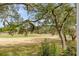 Scenic view of the green golf course surrounded by mature trees at 1429 Burningtree Rd, Charleston, SC 29412