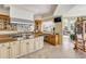 Open kitchen featuring travertine floors, an island cooktop and granite counters, and large windows at 1429 Burningtree Rd, Charleston, SC 29412