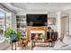 Living room with a fireplace, bookshelf, and large picture window providing natural light at 1429 Burningtree Rd, Charleston, SC 29412