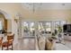 Bright living room with tile floors opens to an outdoor balcony with views of the golf course at 1429 Burningtree Rd, Charleston, SC 29412