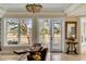 Bright living room with a leather sofa, large windows and doorway to the backyard, and travertine flooring at 1429 Burningtree Rd, Charleston, SC 29412