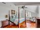 Brightly lit primary bedroom featuring a four poster bed, hardwood floors, and designer appointments at 1429 Burningtree Rd, Charleston, SC 29412