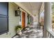 Inviting porch with decorative lanterns, black shutters, and a seating area, perfect for relaxing outdoors at 1429 Burningtree Rd, Charleston, SC 29412