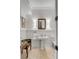 Well-appointed powder room with pedestal sink, decorative mirror, and wainscoting at 1429 Burningtree Rd, Charleston, SC 29412