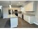 Close-up of kitchen with stainless appliances, granite countertops, and white cabinetry at 149 Rose Ave, Walterboro, SC 29488