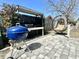 Back patio area with a grill, outdoor kitchen prep area, and a comfortable pod-style swing on a paved surface at 1545 Ashley River Rd # 3K, Charleston, SC 29407